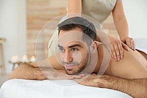 Handsome man receiving back massage