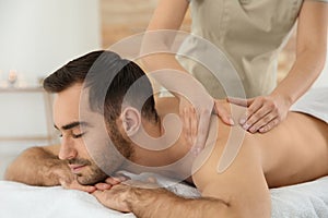 Handsome man receiving back massage