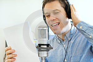 Handsome man recording a song.