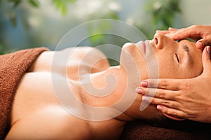 Handsome man relaxing in spa salon