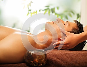 Handsome man relaxing in spa salon