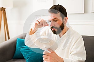 Handsome man removing facial hair