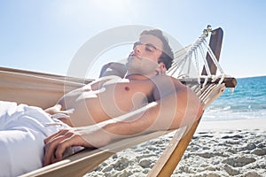 Handsome man resting in the hammock