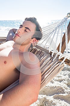 Handsome man resting in the hammock