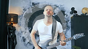 Handsome man rock musician plays an electric guitar in a stylised studio