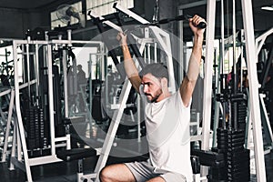 Handsome Man is Rowing Exercise With Bodybuilder Equipment in Fitness Club.,Portrait of Strong Man doing Working Out Calories