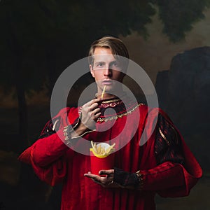 Handsome man in a Royal red doublet eating French fries.