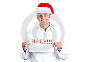 Handsome man in santa hat with a help! sign in his hands