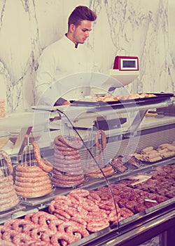 Handsome man seller working at meat market