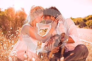 Handsome man serenading his girlfriend with guitar photo