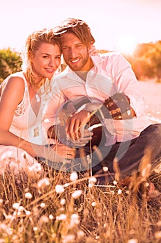 Handsome man serenading his girlfriend with guitar photo