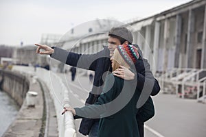 Handsome man showing his girlfriend where he used to fishing with his father