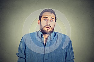 Handsome man shrugging shoulders showing ignorance photo