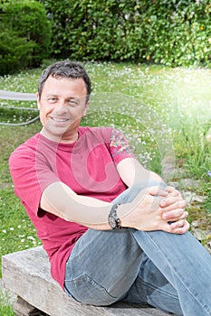 handsome man sit on bench garden on summer