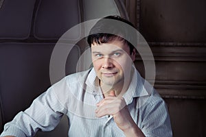 Handsome man sitting in an old chair