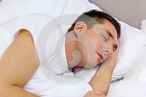 Handsome man sleeping in bed