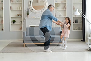 Handsome man spending time at home with his cute little daughter. Happy Father`s Day! Dad and daughter