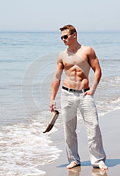 Handsome man standing on beach