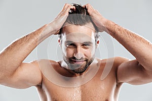 Handsome man standing isolated over grey background