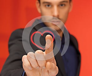 Handsome man in suit pressing virtual button