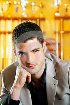 Handsome man with suit sitting in billiard pool