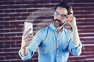 Handsome man taking picture of himself