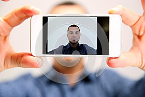 Handsome man taking selfie