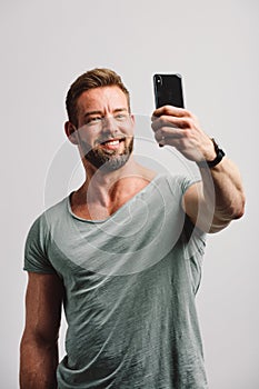 Handsome man taking selfie on the phone