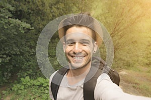 Handsome man taking a selfie on vacation in summertime