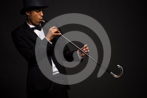 Handsome man in top hat posing with cane