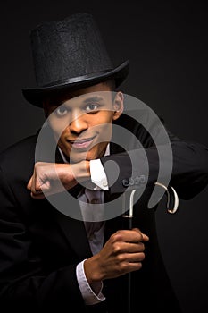 Handsome man in top hat posing with cane