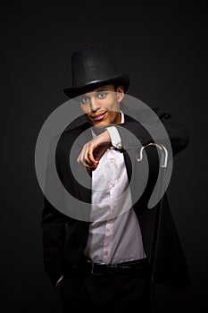 Handsome man in top hat posing with cane