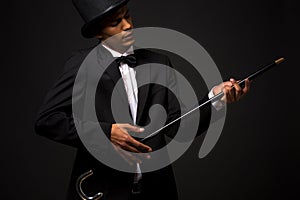 Handsome man in top hat posing with cane