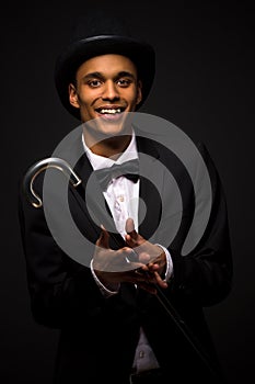 Handsome man in top hat posing with cane