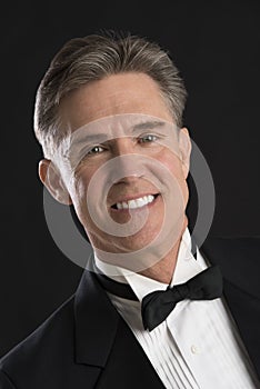 Handsome Man In Tuxedo Isolated Over Black Background