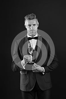 Handsome man tuxedo suit drink champagne black background, celebrate anniversary concept