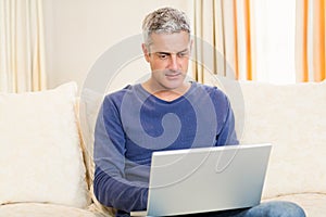 Handsome man using laptop