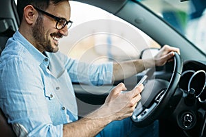 Handsome man using navigation system while driving car