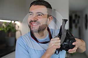 Handsome man using a retro video camera
