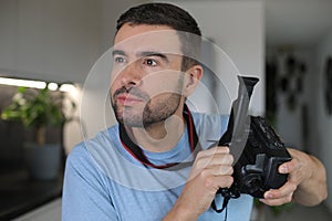 Handsome man using a retro video camera