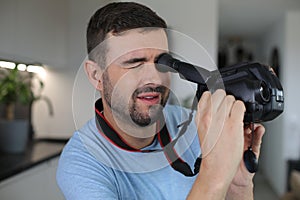 Handsome man using a retro video camera