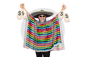 Handsome man in vivid poncho holding money bags