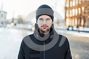 Handsome man in warm winter clothing walking in the city