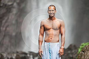 Handsome man at waterfall