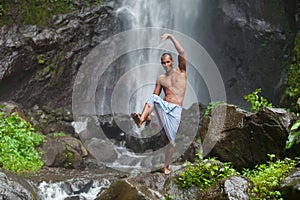 Handsome man at waterfall