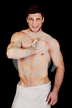Handsome man waxing his chest.