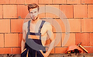 Handsome man wear overalls. Construction. Worker brick wall background. Perform basic tasks. Masculinity concept