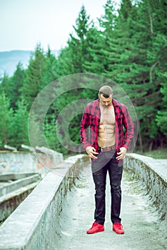 Handsome man wearing checked shirt outdoors