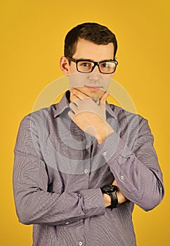 Handsome man wearing glasses touch chin. Friendly face portrait of an unshaven man with glasses. Businessman with smart