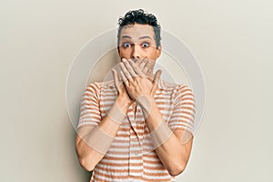 Handsome man wearing make up wearing casual t shirt shocked covering mouth with hands for mistake